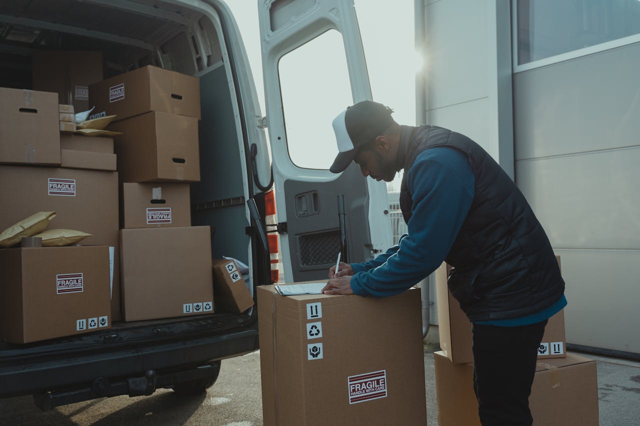 The Art of Drawing Readers In: Your attractive post title goes here Delivery worker sorting and organizing cardboard boxes in van for shipment.